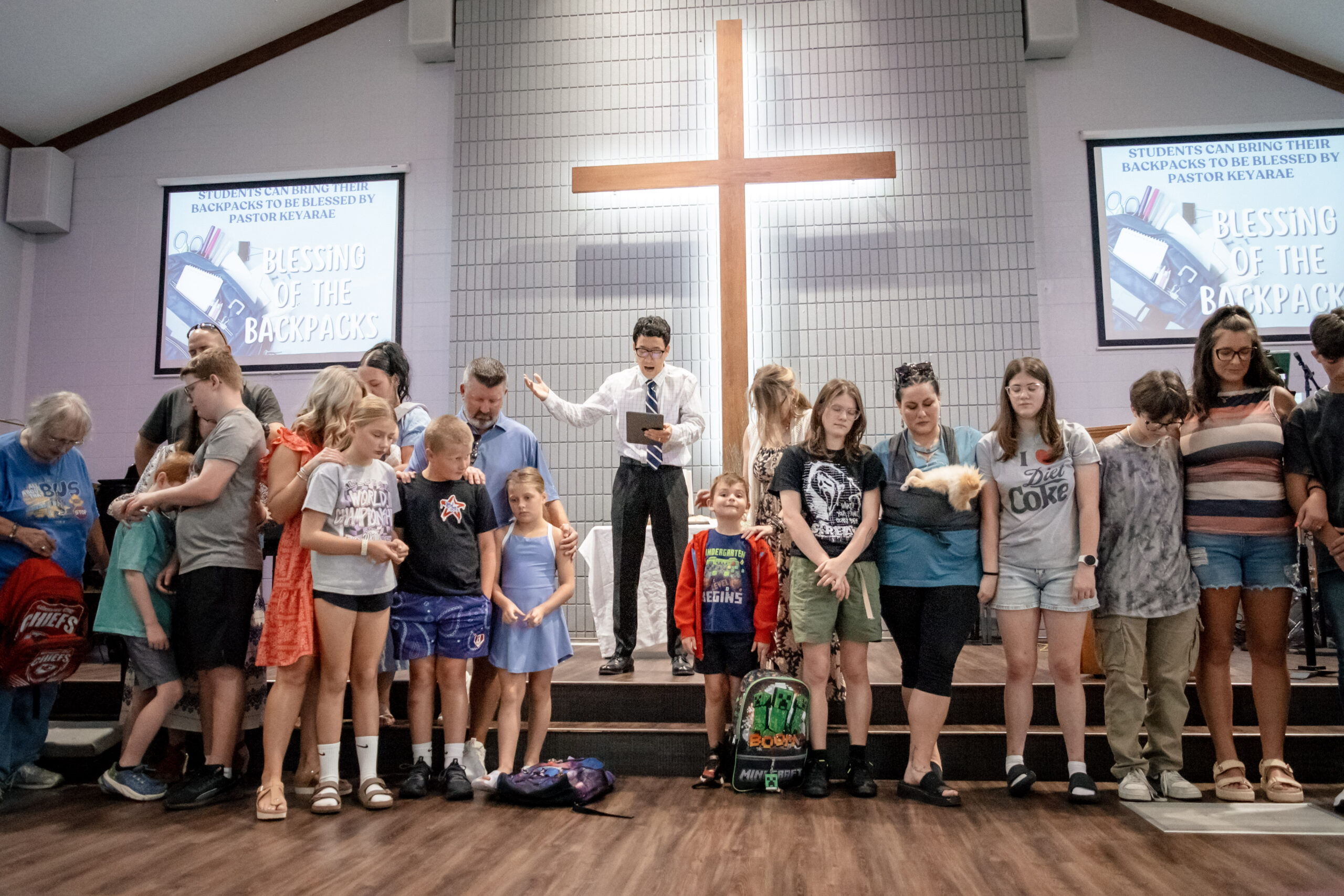 pastor praying over families